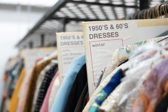 Rack of 1950's and '60's era winter dresses.